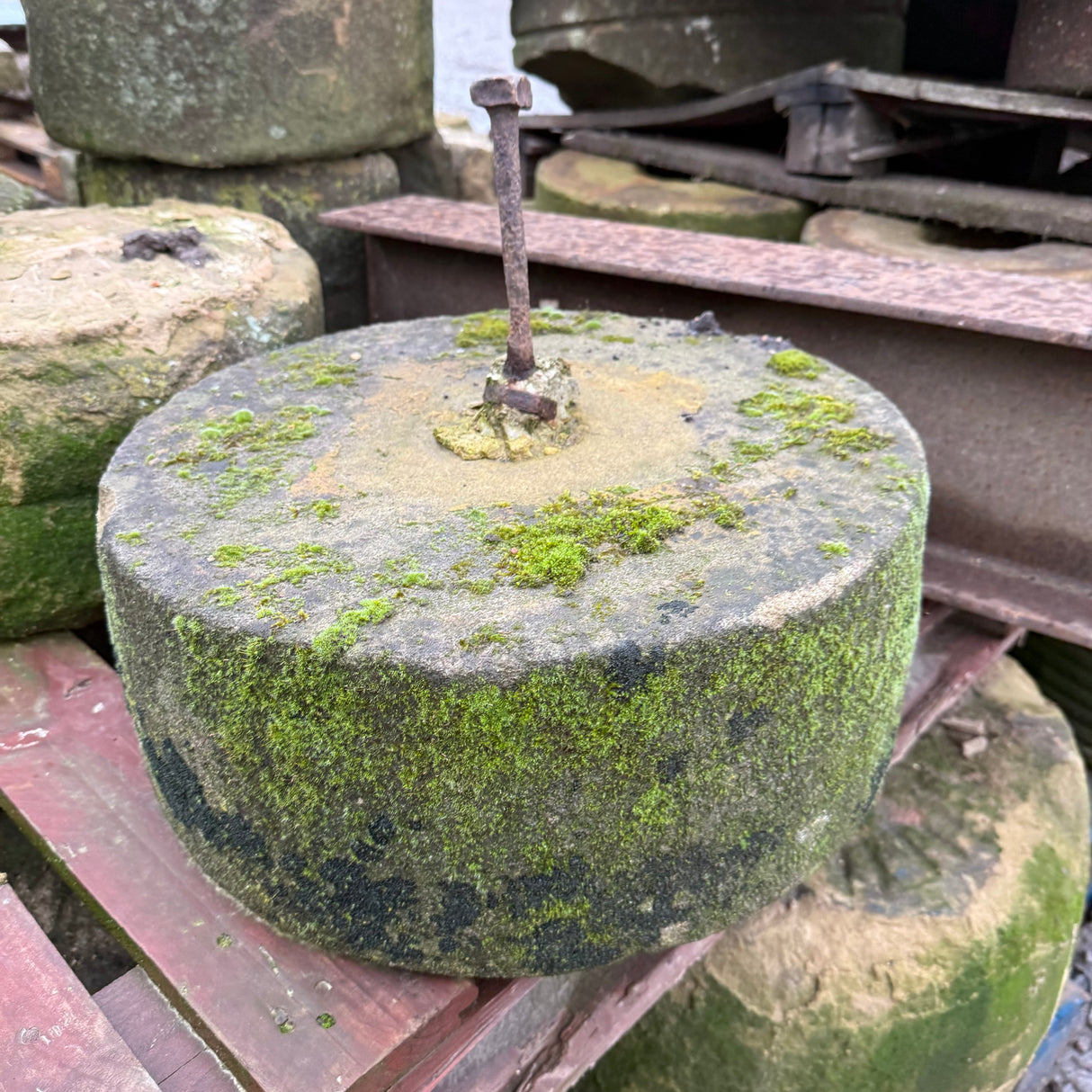 Reclaimed Mill Stone with Metal Bar