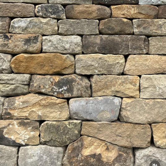 wall built using reclaimed stone cladding