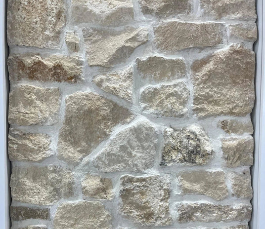 Close-up of a stone wall with varying stone sizes and colors.