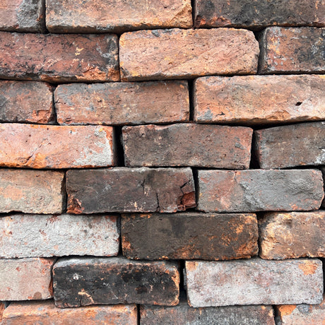 Reclaimed 3 inch Victorian Handmade Imperial Bricks stacked in a rustic pattern - Reclaimed Brick Company