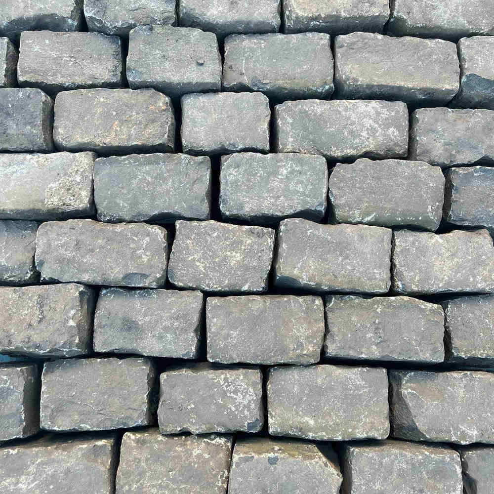 Stacked reclaimed granite setts for a traditional cobblestone driveway