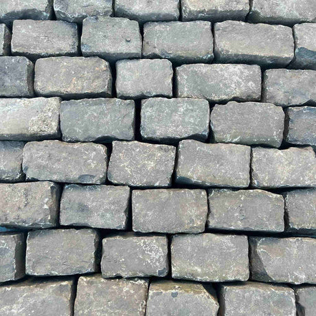 Stacked reclaimed granite setts for a traditional cobblestone driveway