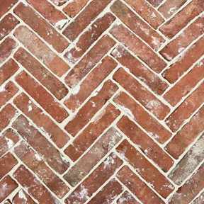 Close-up of red brick pattern with a herringbone layout
