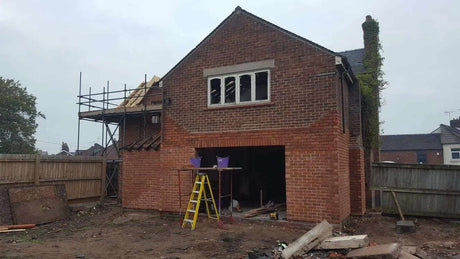 Brick slip external cladding installation in progress on rear wall of house