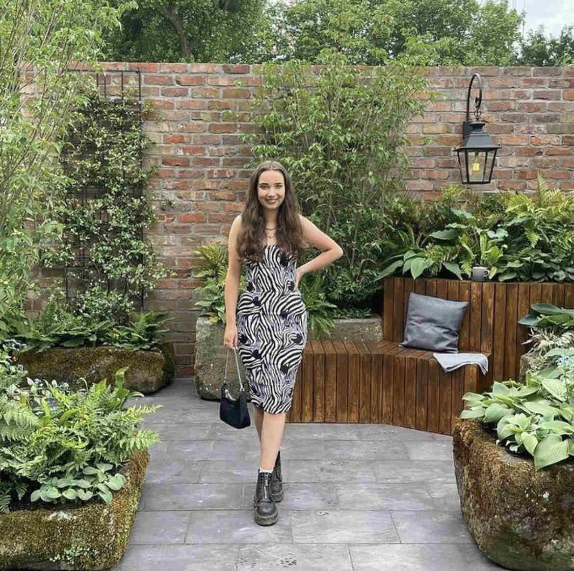 Visitor standing beside brick slip garden wall at RHS Chelsea Flower Show
