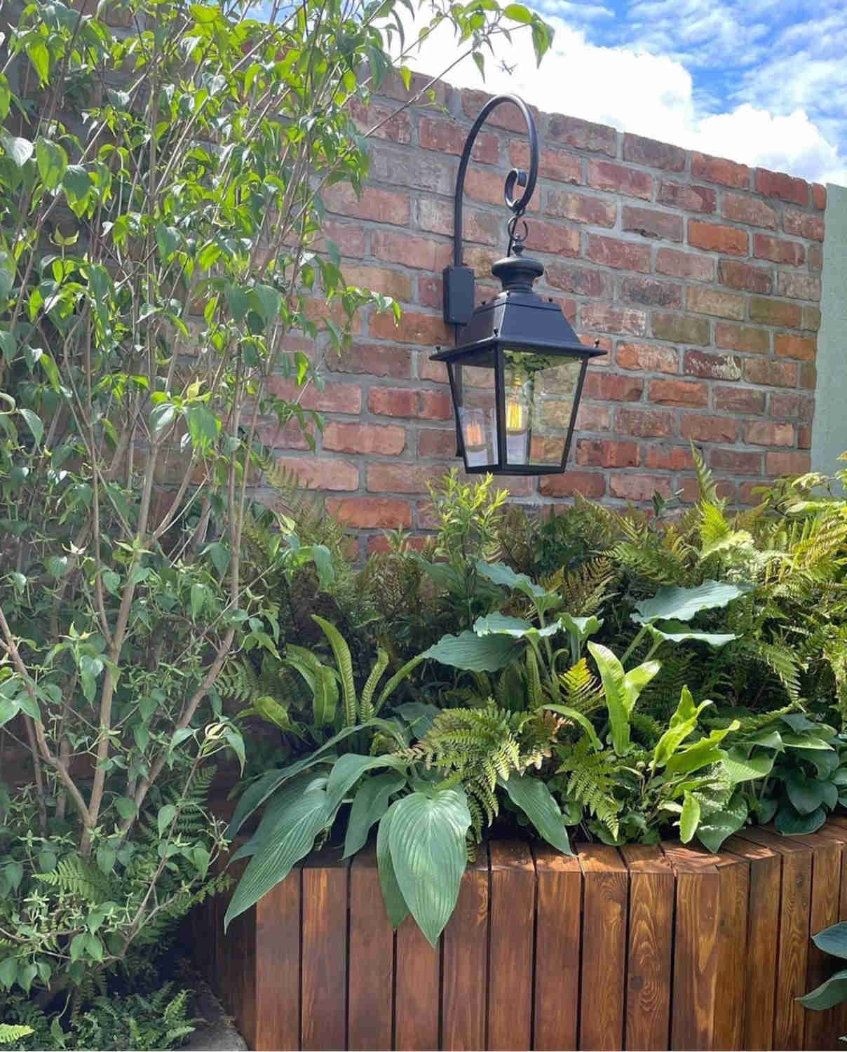 Outdoor garden wall built with reclaimed brick slips in show garden