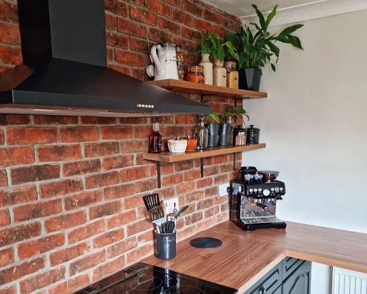 Exposed brick slip feature wall in modern kitchen interior