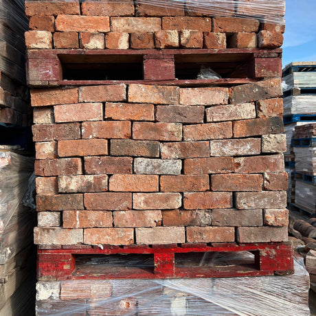 Reclaimed barn handmade imperial bricks stacked in a neat pattern - Reclaimed Brick Company
