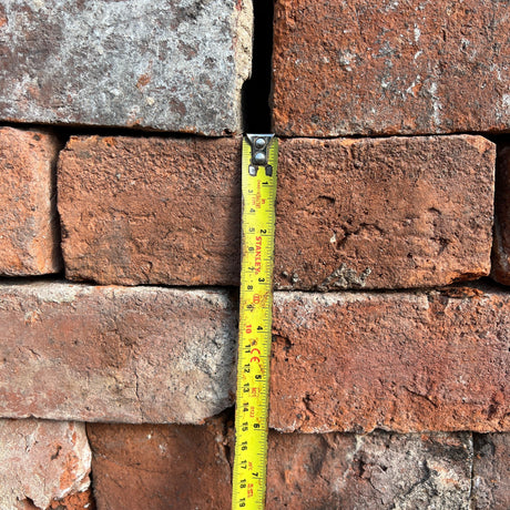 Weathered red brick with textured surface